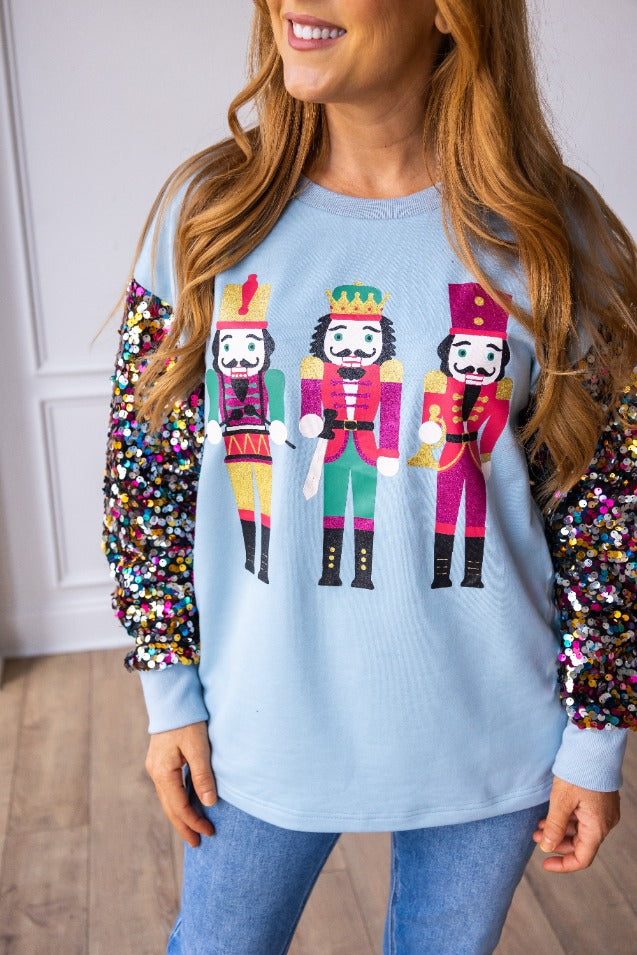 Nutcrackers on Blue Sweatshirt with Sequin Sleeves