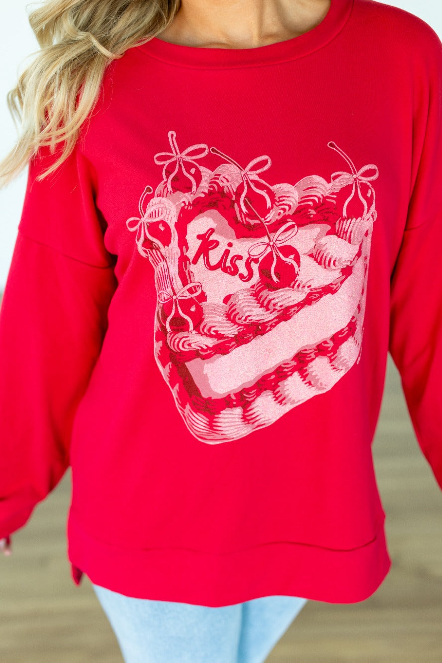 Kiss Cake on Red Sweatshirt